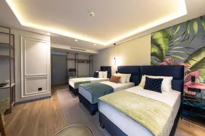 a hotel room with two beds and a painting on the wall at Calisi Hotel in Belgrade