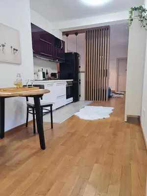 a kitchen with a table and a dining room at Dimiant Lux Apartment in Vračar (historical)