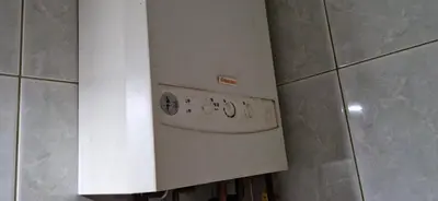 a stove in a tiled kitchen with a white wall at Julija 3 in Pančevo