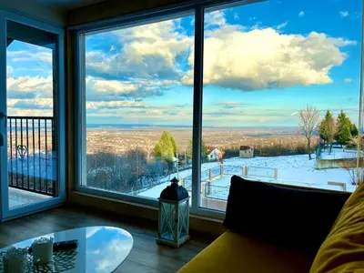 a room with a large window looking out at a snow covered yard at Imanje POGLED in Arandjelovac