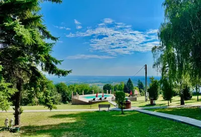 a park with a swimming pool and a bench at Imanje POGLED in Arandjelovac