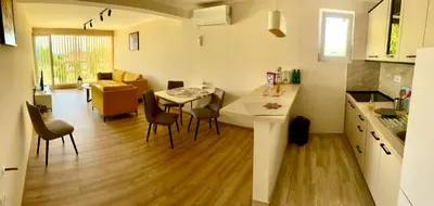 a kitchen and living room with a table and chairs at Imanje POGLED in Arandjelovac
