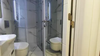 a bathroom with a toilet and a glass shower at Milash in Karaburma