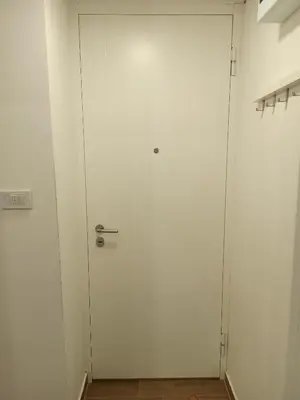 a white door with a handle in a room at Milash in Karaburma