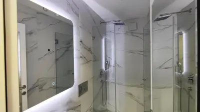 a bathroom with a shower and a mirror at Milash in Karaburma