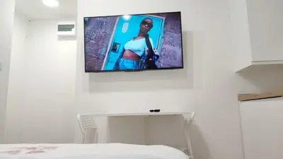 a television hanging on a wall in a bedroom at Milash in Karaburma