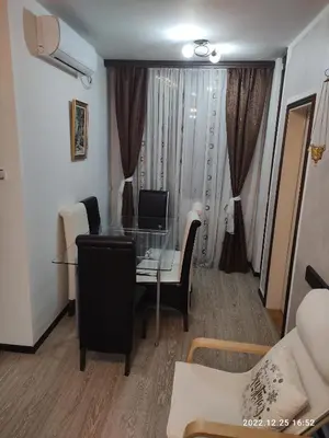 a living room with a glass table and a computer at Stan na dan in Resnik