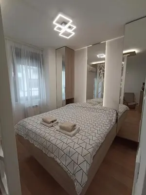 a bedroom with a bed with two pillows on it at Galija apartment in Belgrade