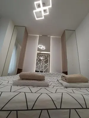a bedroom with a large bed with two pillows on it at Galija apartment in Belgrade