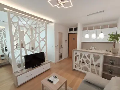 a living room with a couch and a tv in it at Galija apartment in Belgrade