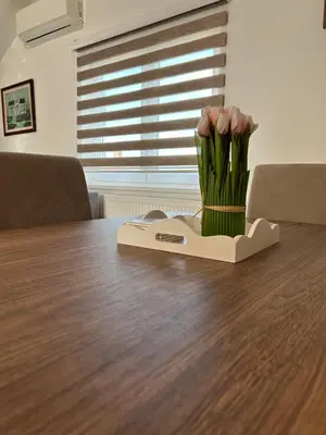 a bouquet of flowers sitting on a table at Apartman Dunja in Arandjelovac