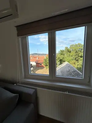 a window in a room with a couch and a view at Apartman Dunja in Arandjelovac