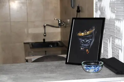a framed picture on a table with a glass at Gorila 1 in Voždovac