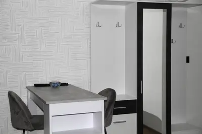a desk and chairs in a room with white walls at Gorila 1 in Voždovac
