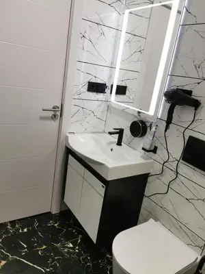a bathroom with a sink and a toilet and a mirror at Gorila 1 in Voždovac