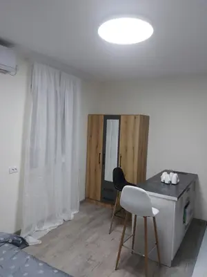 a white room with a table and a chair at Apartman mikikiki in Belgrade