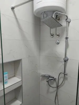 a shower with a shower head in a bathroom at Apartman mikikiki in Belgrade