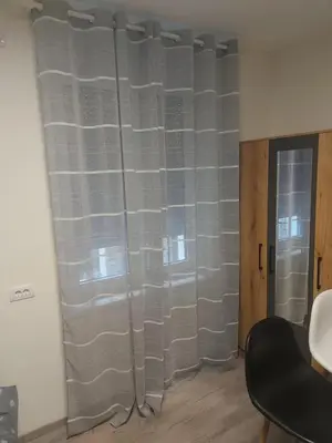 a room with a window with gray curtains at Apartman mikikiki in Belgrade