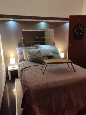 a bedroom with a large bed with a table on it at Apartman K2 in Žarkovo