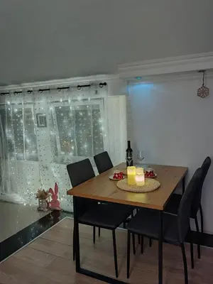 a dining room with a table and chairs and a window at Apartman K2 in Žarkovo