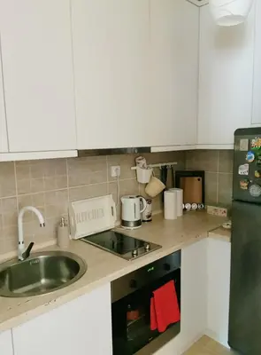 a kitchen with a sink and a stove top oven at Lux apartman Lena in Belgrade