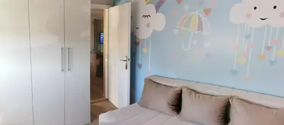 a living room with a white couch and a blue wall at Lux apartman Lena in Belgrade