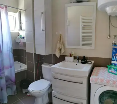 a bathroom with a white toilet and a sink at Lux apartman Lena in Belgrade