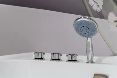 a bathroom sink with a blue shower head on a counter at Apart Hotel Maksimum in Belgrade