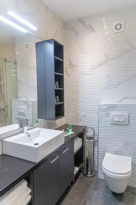 a bathroom with a white sink and a toilet at Apart Hotel Maksimum in Belgrade