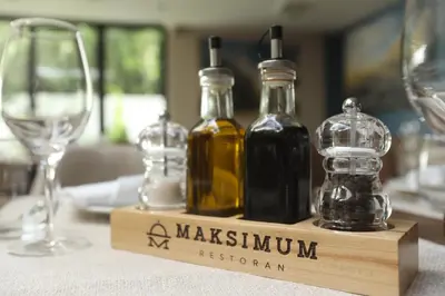 a table with two bottles of wine and a glass at Apart Hotel Maksimum in Belgrade