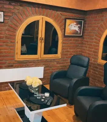 a living room with two chairs and a table at Apartman17 in Belgrade