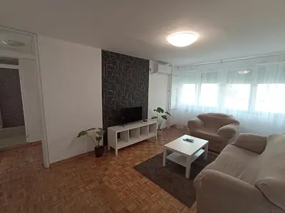 a living room with a couch and a tv at Apartment Fiesta in Novi Beograd
