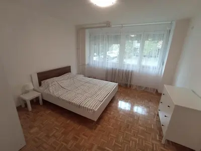 a small bedroom with a bed and a window at Apartment Fiesta in Novi Beograd