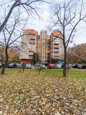 a park with trees in front of a building at Apartment Fiesta in Novi Beograd
