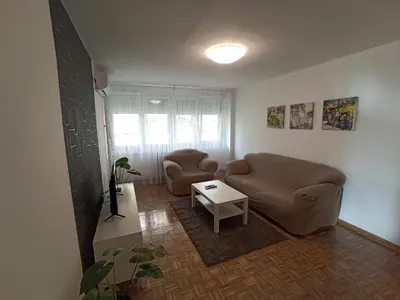 a living room with two chairs and a table at Apartment Fiesta in Novi Beograd
