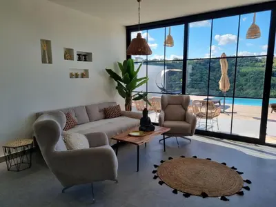 a living room with a couch and chairs and a table at Vila lake in Karaula
