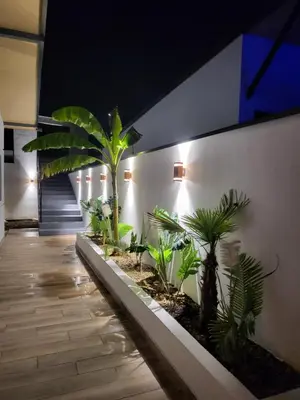 a hallway with palm trees in a building at Vila lake in Karaula