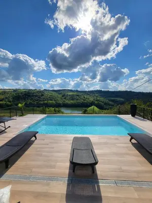 a swimming pool with a view of a lake at Vila lake in Karaula