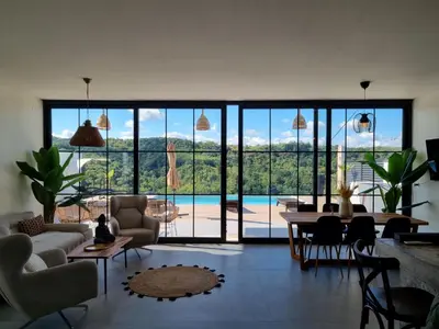 a living room with a view of a pool at Vila lake in Karaula