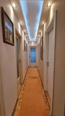 a hallway with a long corridor with a ceiling at Sava Centar in Novi Beograd