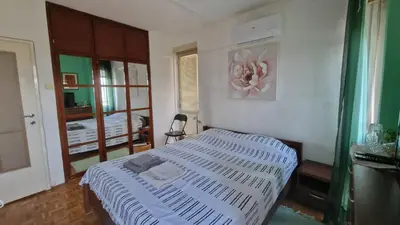 a bedroom with a bed with a white comforter at Sava Centar in Novi Beograd
