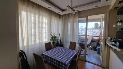 a table and chairs in a room with a window at Sava Centar in Novi Beograd