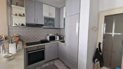 a small kitchen with a stove and a microwave at Sava Centar in Novi Beograd