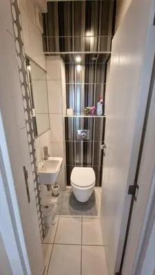 a small bathroom with a toilet and a sink at Sava Centar in Novi Beograd