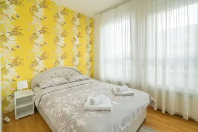 a bedroom with a bed with two towels on it at Delta Residence Belville in Belgrade