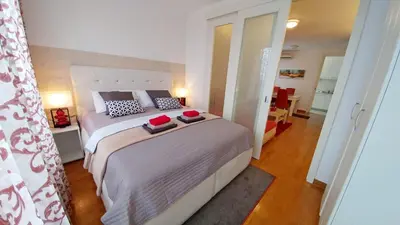 a bedroom with a bed with two books on it at Delta Residence Belville in Belgrade
