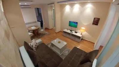 an overhead view of a living room with a couch and a television at Delta Residence Belville in Belgrade