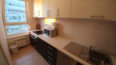 a kitchen with a sink and a microwave on a counter at Delta Residence Belville in Belgrade