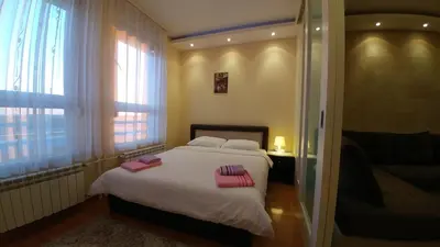a bedroom with a bed with two towels on it at Delta Residence Belville in Belgrade