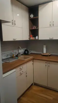 a kitchen with white cabinets and a sink at Kapetan Misina-Nina in Belgrade
